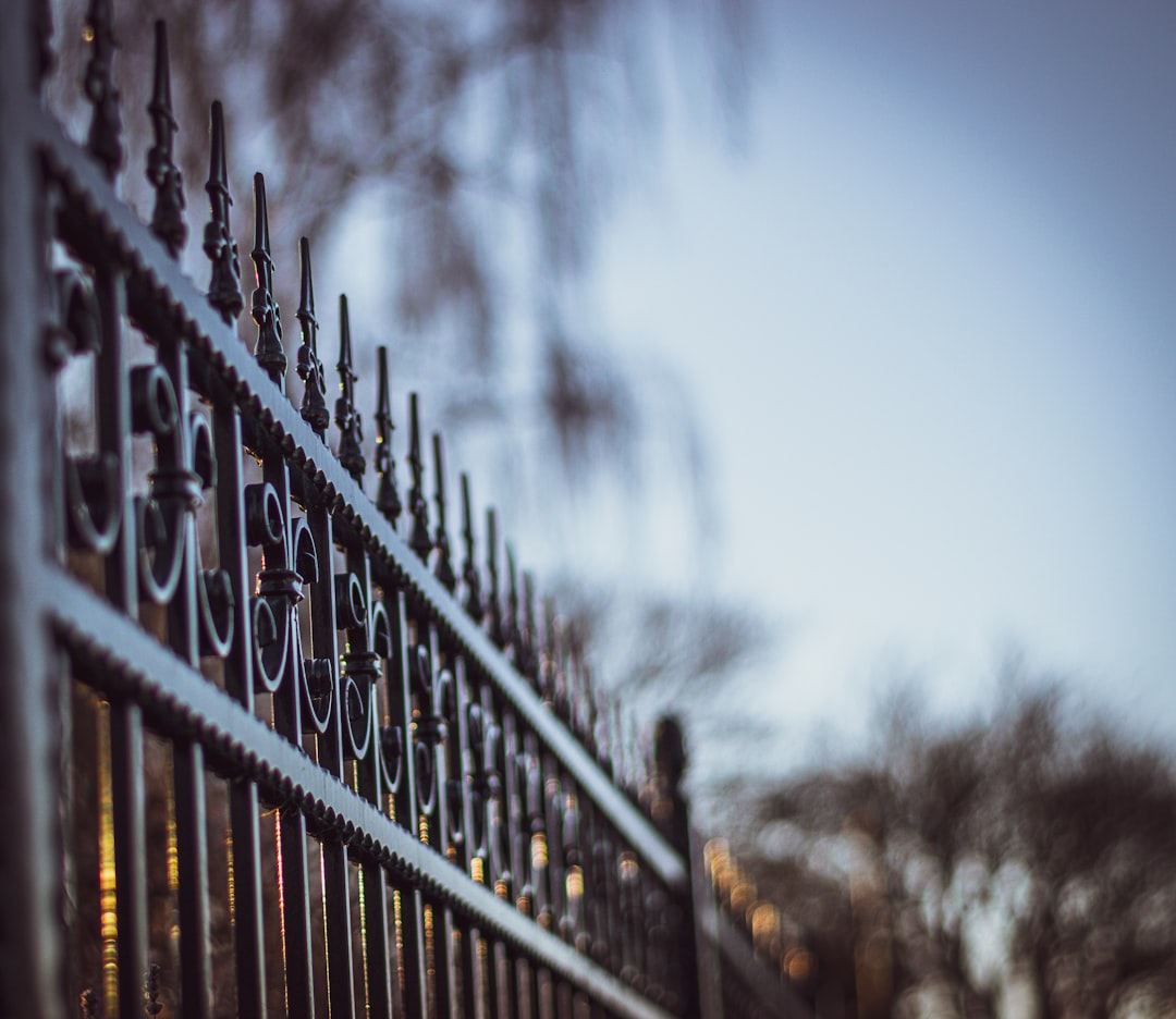 about-02 black-metal-fence-during-daytime-ctoccqfzqpq